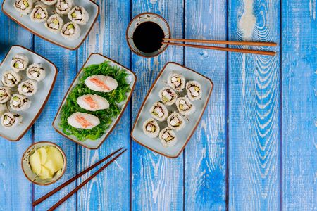 Chinese cuisine. Set of philadelphia sushi roll with soy sauce, ginger and chopstick.の写真素材