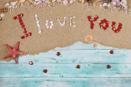I love you taxt made from sea shells with red starfish. Valentines day concept.