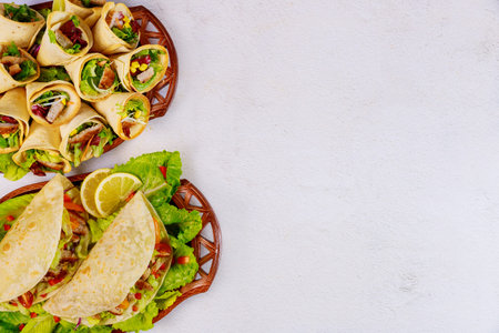 Delicious soft flour tortillas with salad and meat. Mexican cuisine.