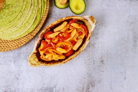 Fajita in baking tray with spinach tortillas on white background. Mexican cuisine.の写真素材