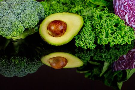 Vegetables reflection in the smooth black surface.の写真素材