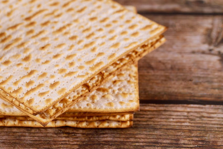 Jewish matzah bread on wooden rustic background. Passover holiday concept