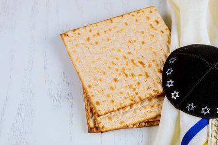 Matzo, tallit and kippa on white background. Jewish holiday concept.の写真素材