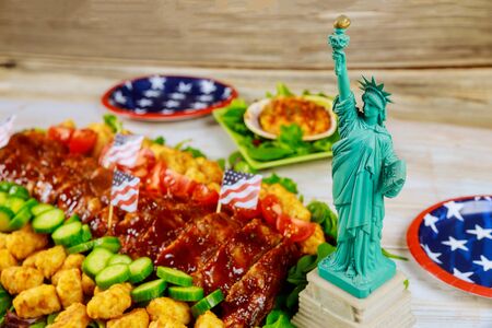 American food on party table with Statue of Liberty.の写真素材