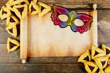 Papyrus roll with Purim cookies and mask. Jewish holiday concept.の写真素材