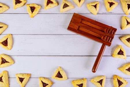 Purim background with noise maker and hamantaschen triangle cookies.の写真素材