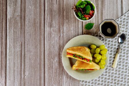Healty grilled cheese sandwich with golden grape and cup of coffee for breakfast. Top view.の写真素材