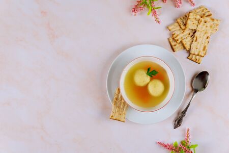 Delicious matzo ball soup with carrot and matzos bread. Top view. Jewish holiday concept.の写真素材