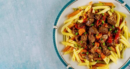 Penne color pasta with beef and bolognese sauce and vegetable.の写真素材