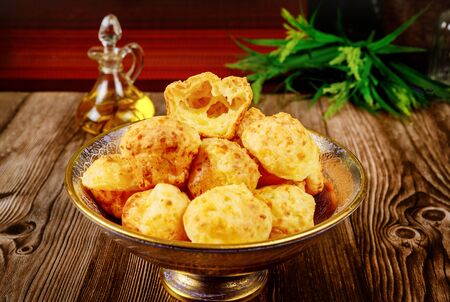 Cooked brazilian cheese bread chipa in bowl on wooden background.の写真素材