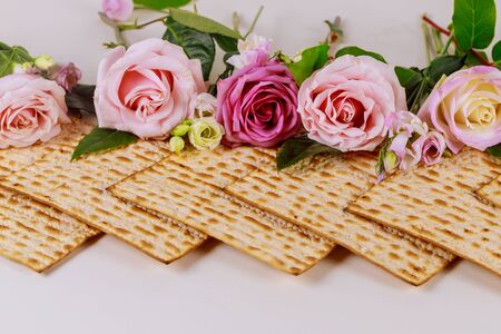 Israeli matzah bread with pink roses. Jewish Passover holiday concept.の写真素材