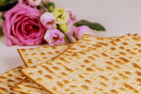 Jewish matzah bread with pink roses. Jewish Passover holiday concept.の写真素材