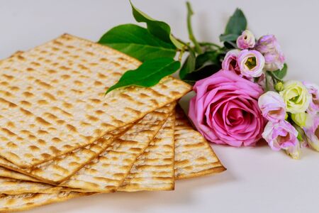 Matzah bread with pink roses. Jewish Passover holiday concept.の写真素材