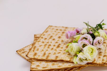 Israeli matzah bread with pink and white roses. Jewish Passover holiday concept.の写真素材