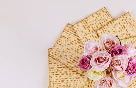 Jewish matzah bread with pink flowers on white background. Passover holiday conceptの写真素材