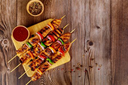 Kebab on wooden stick with spicy sauce.の写真素材