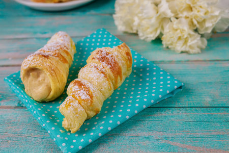 Puff pastry rolls stuffed with sweet cream and flowers.