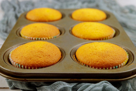 Plain homemade cupcakes in baking tray. Close up.