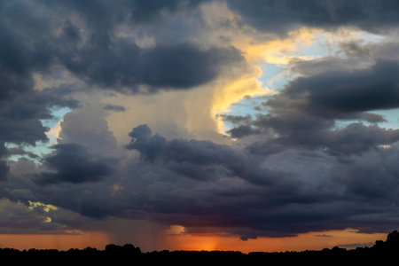 Sunset with dark clouds, rain, tornado or hurricane. Weather concept.