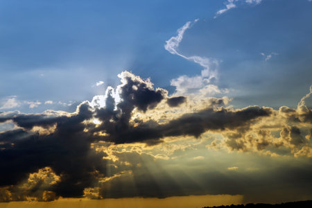 Dramatic sunset with sunbeam and dark cloud. Nuture concept.