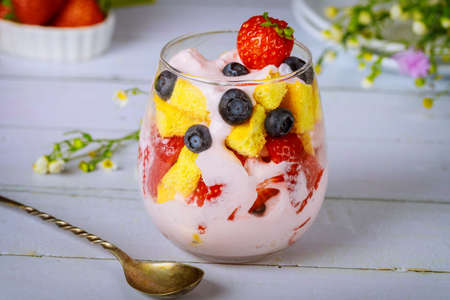 Fruit trifle with pound cake and yogurt in glass with spoon.の写真素材