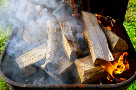 Grill outdoor with firewood and smoke for making barbecue.の写真素材