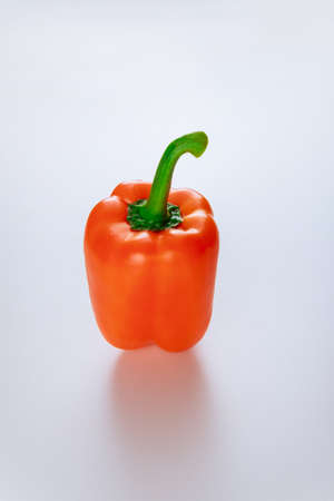 Fresh ripe orange bell pepper isolated on white. Produce product.の写真素材
