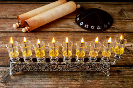 Menorah with burning oil candles and kippah with totah for Hanukkah. Jewish holiday.
