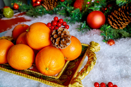 Seasonal oranges in christmas tray with ornament. New Year or Christmas concept.の写真素材
