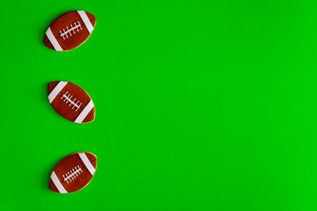 Cookie as an american football ball isolated on green background. Top view.の写真素材
