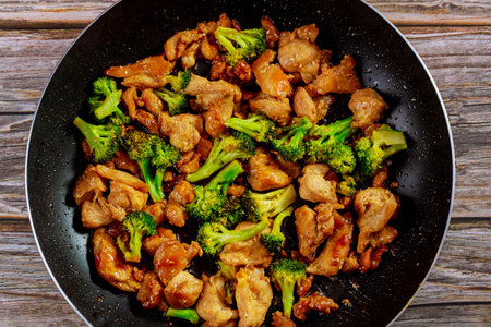 Stir fry with chicken and broccoli on wok. Chinese food. Close up.の写真素材