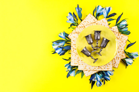 Jewish matzah bread on yellow background. Passover holiday concept.