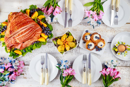 Table setting with baked pork ham on Easter table. Holiday concept.の写真素材