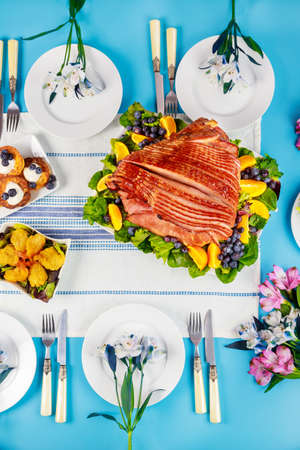 Spiral sliced glazed ham on festive Easter table. Holiday concept.の写真素材