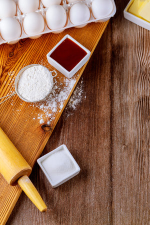 Ingredients for baking cookies flour, eggs and sugar with rolling pin.