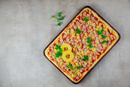 Top view of homemade pineapple, cheese and sausage pizza in pan. Fast food.の写真素材