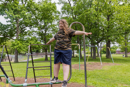 Teenager girl doing physical exercise for slimming on playground.