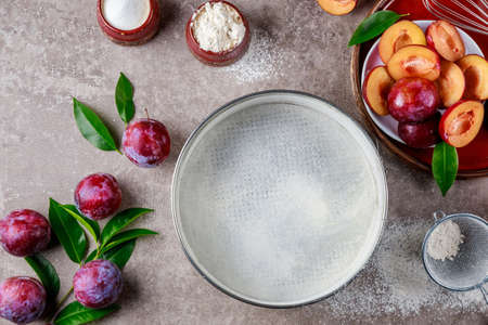 Preparation dessert plum pie on kitchen table. Top view.の写真素材