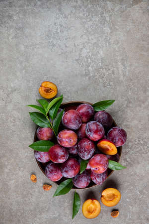 Big plate of juicy ripe red plum. Top view.の写真素材