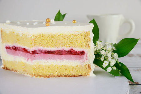 Festive cut sponge cake with strawberry filling. Close up.