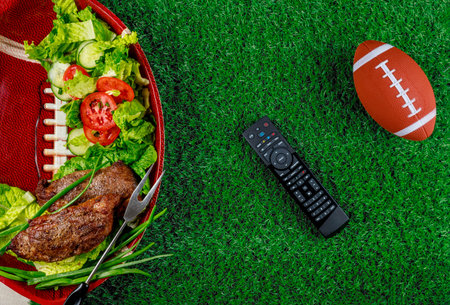 Appetizers on the plate with tv remote controller for the football party. Top view.の写真素材