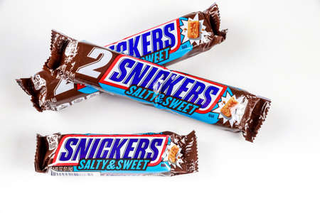 May 4, 2021. New York. Salty and sweet Snickers bar with crunchy peanut and nougat covered in milk chocolate.のeditorial素材