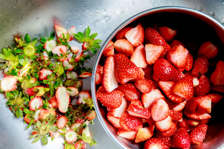 Fresh strawberries are cleaned and cut into piecesの写真素材