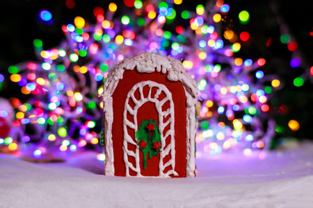 Gingerbread house over defocused the Christmas tree lights.の写真素材