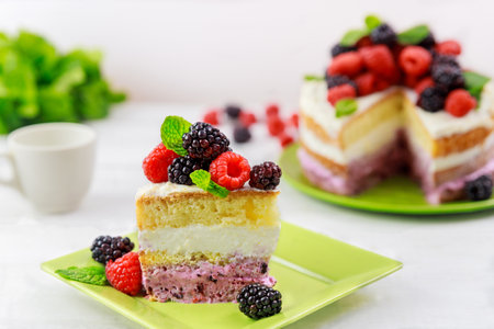 Fresh raspberries and blackberries are used to decorate this homemade berry cake.の写真素材