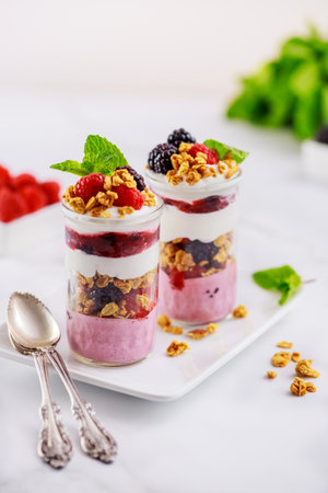 Greek yogurt, fruit, and granola on top of pannacotta.の写真素材