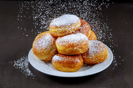 Homemade donuts in white plate powdering with sugar.の写真素材