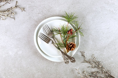 Christmas white table setting with pine branch decorations.の写真素材