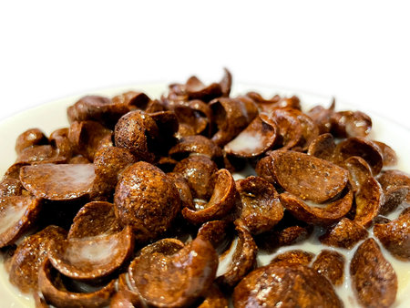 Close up of a delicious chocolate cereal and milk in a white bowl for breakfast