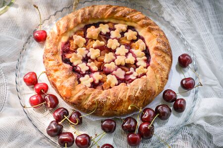 pie on plate with cherryの写真素材